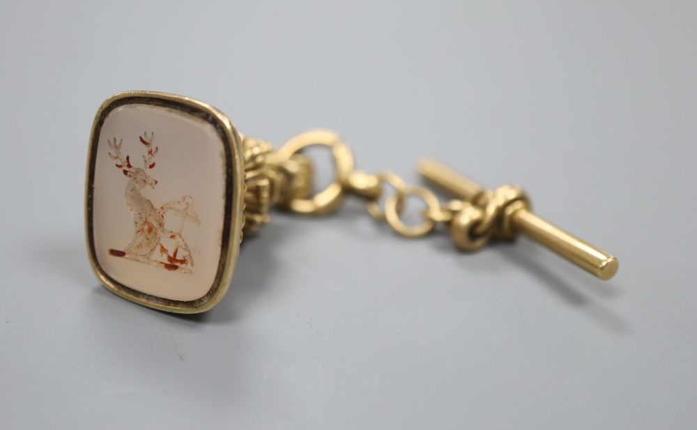 A Regency gold seal with chalcedony intaglio of a heart with an anchor, with short 18ct gold chain a T bar, 22 grams (gross)
